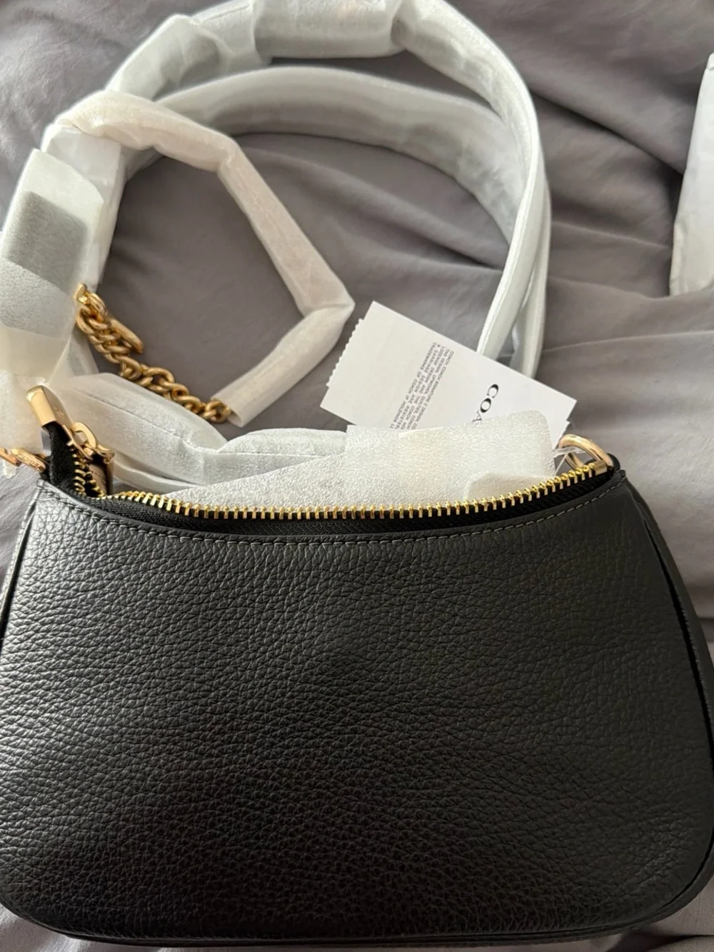 COACH Teri Mini Black Pebbled Leather Shoulder Bag with Gold Hardware.